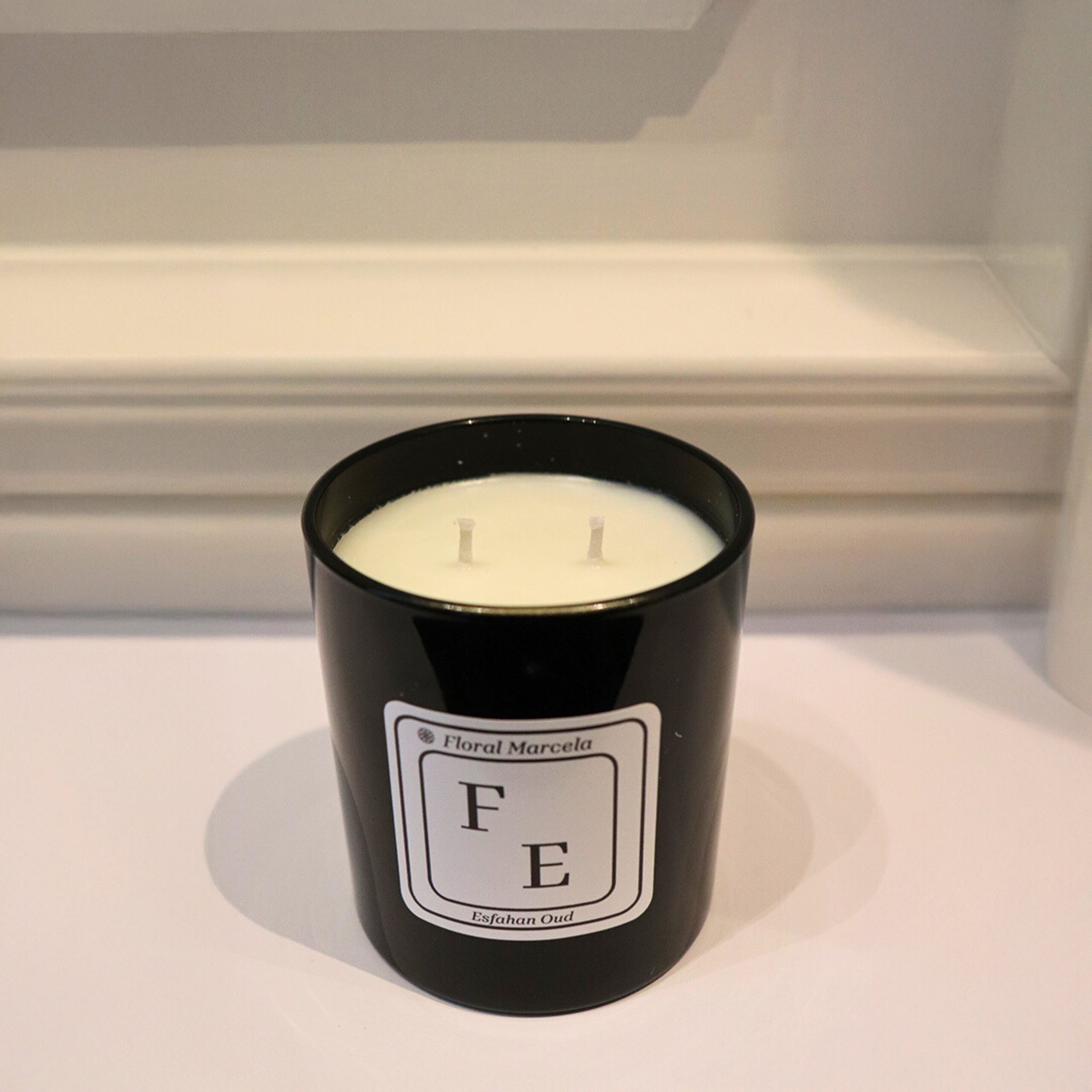 Medium Esfahan Oud candle in sleek black glass with dual wicks