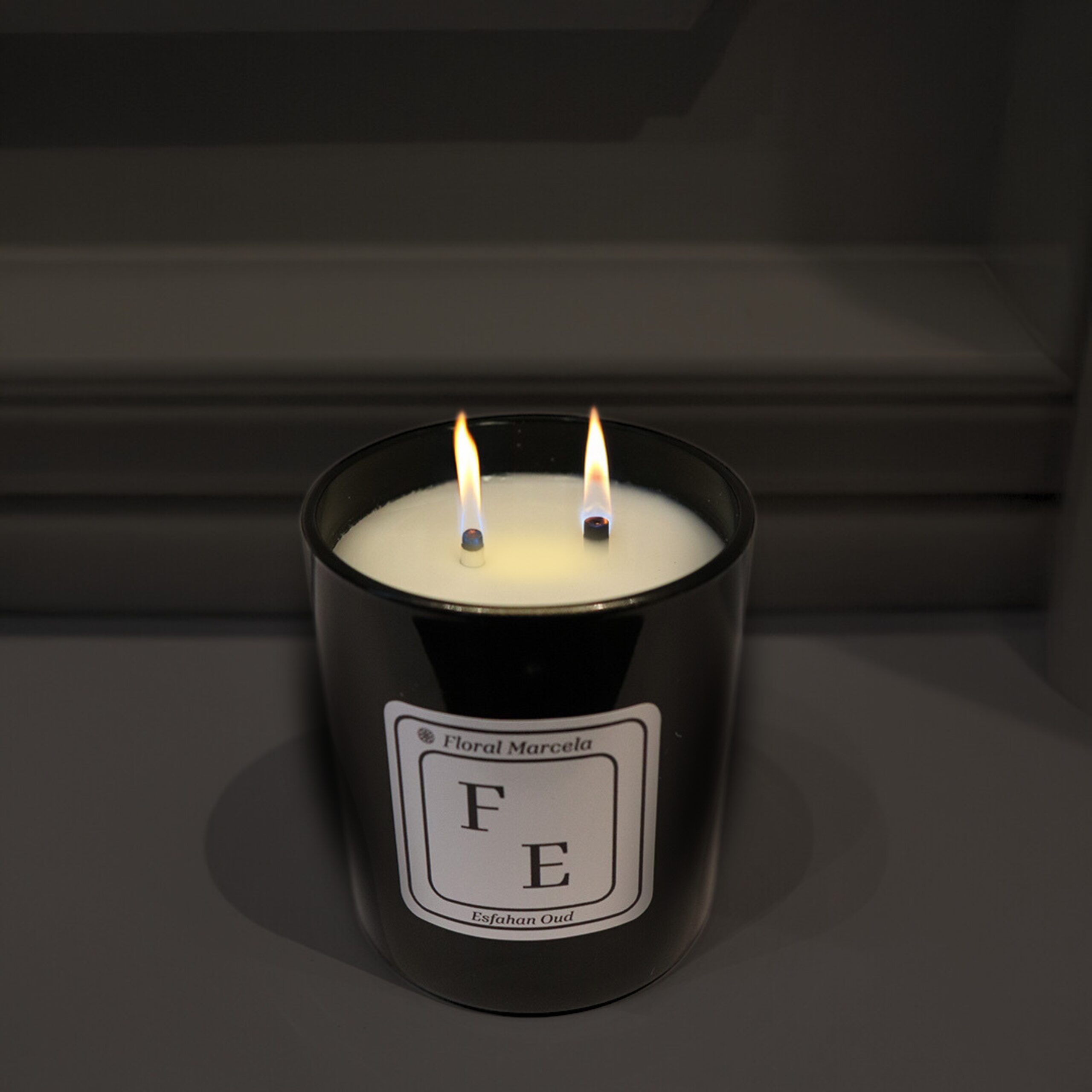 Medium Esfahan Oud candle in sleek black glass with dual wicks
