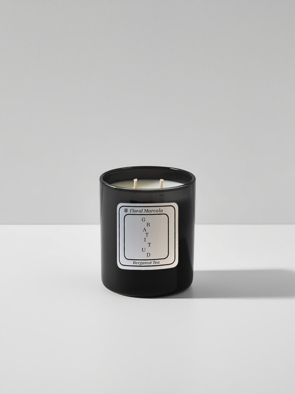 Bergamot Tea Scented Candle in a sleek black glass jar from Floral Marcela